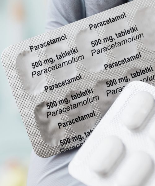 Hand holding paracetamol medicine packets