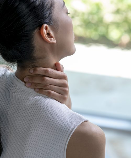 Asian woman has neck and shoulder pain. Female holding painful neck with another hand. People with body-muscles problem, Healthcare And Medicine.