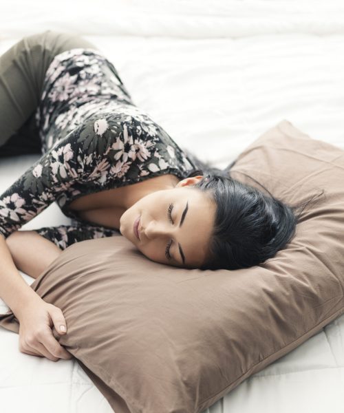 Young beautiful woman lying down on the bed and resting in the afternoon, lifestyle and relax concept