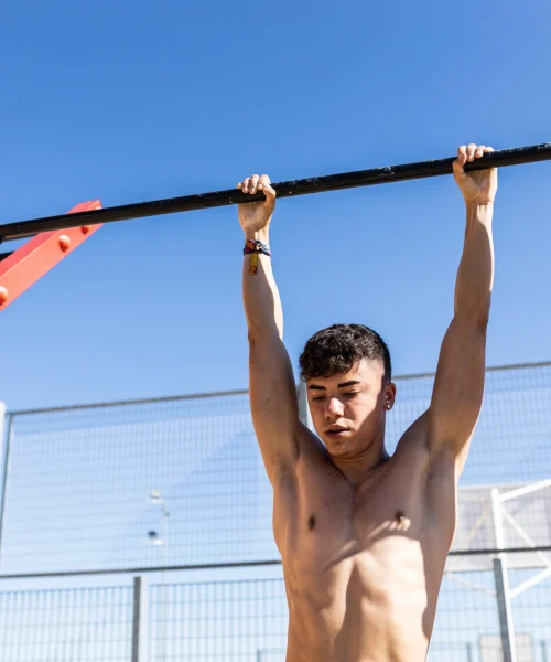 young-man-doing-pull-ups-outdoors-on-sunny-day-2026-01-07-01-42-28-utc